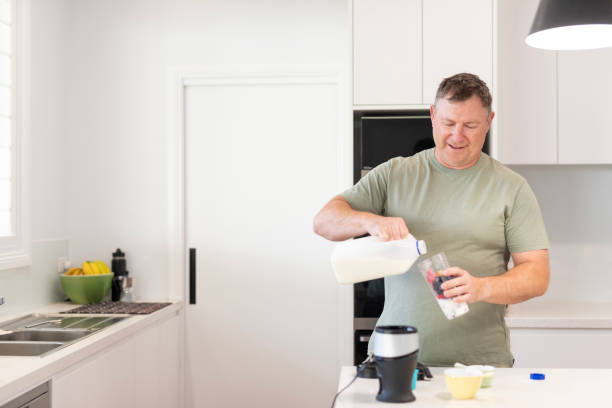 istock Middle aged man making a healthy smoothie 1698307807