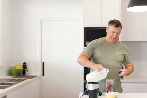 istock Middle aged man making a healthy smoothie 1698307811