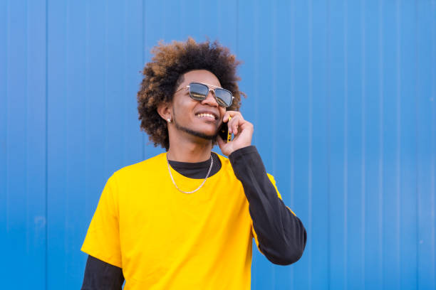 istock Happy mixed race man talking to the mobile phone 1698309938