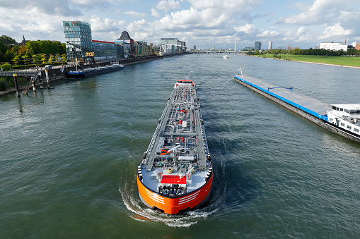 Inland vessel passes the Rheinauhafen near Cologne