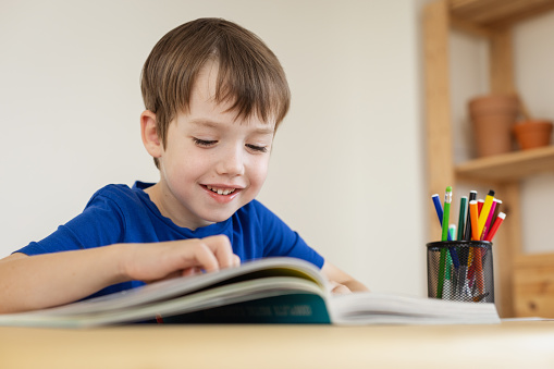 6 year old boy reading a book