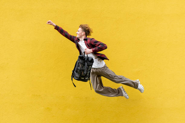 istock young guy student with backpack flies forward and hurries to study, man in superman pose jumps and runs in the air 1698366823