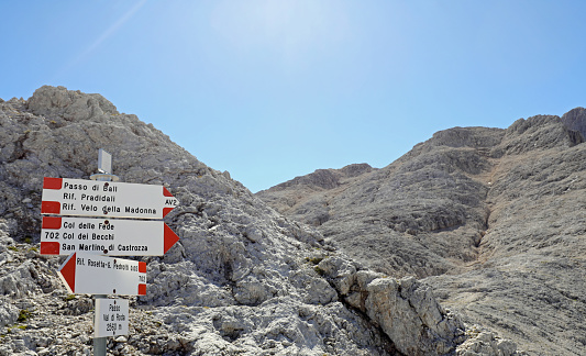 Trail marker in the mountain path with place in italian language without people