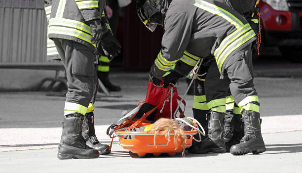 istock Firefighters carry the injured person on a stretcher after the accident 1698378564