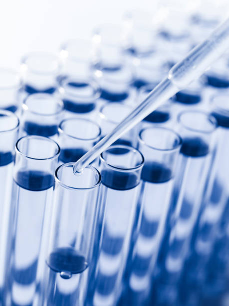 istock Droplet Falling from Pipette into Test Tube. 1698379179