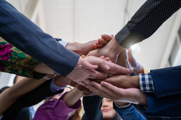 istock Team, teamwork, and unity concept. Diverse team putting hands together. Group of diverse business people. Working together as a team. Partnership and togetherness create a strong sense of community. 1698380842