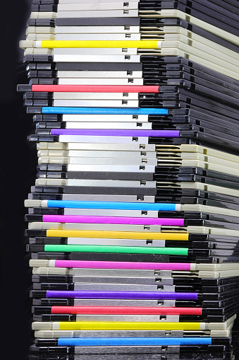 tall pile of old floppy disks where data was saved during the 1990s and 2000s in computers