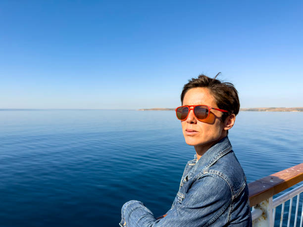 istock A beautiful woman is leaving Bozcaada on a passenger ferry. 1698386921
