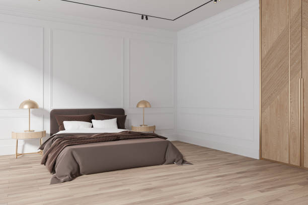 istock White hotel bedroom interior with bed and nightstand with lamp. Mockup wall 1698392505