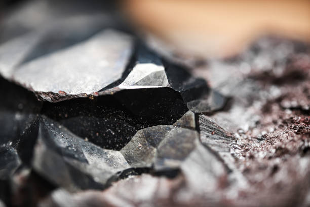 Close-up of raw hematite. Surface of iron ore. Grey reflective mineral texture.Reflective patterns on rock surface. Silver gray background, wallpaper. Extreme macrophotography. Futuristic look, aesthetic.