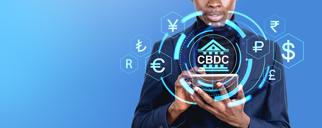Black businessman working with tablet, CBDC hud hologram with digital glowing countries currency symbols. Concept of mobile banking, blockchain and finance