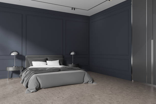 istock Dark home bedroom interior with bed and nightstand with lamp. Copy space wall 1698406637
