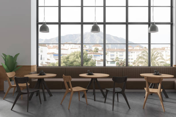 istock Stylish cafe interior with chairs and table, eating space with panoramic window 1698416360