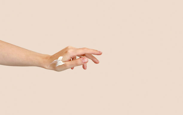 istock Female Hand with cream 1698424189