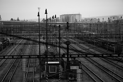 Black and white railroad depot. Industrial district in Brno, Czech Republic. High angle of view. Background wallpaper. Wagons transporting cars. Pollution.