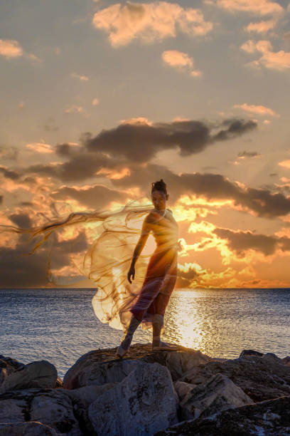 istock Ballerina dancing with thin nylon on the rocks. 1698471895