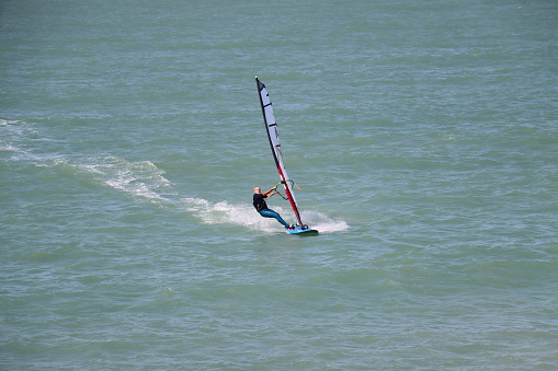 Windsurfer enjoying sunny weekend on the lake.