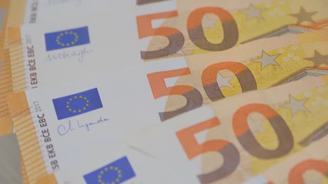 closeup 50 euro banknotes of european union, concept of savings, banking, tax payment, economic cooperation, actual problems of money and monetary circulation, save up for vacation, cash out currency