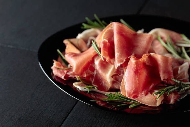 istock Italian prosciutto or Spanish jamon with rosemary. 1698496239