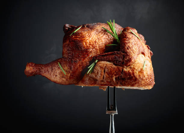 istock Smoked chicken on a fork sprinkled with rosemary. 1698496262