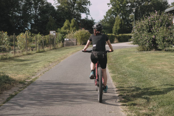 istock A middle -aged woman cycling in nature 1698496945