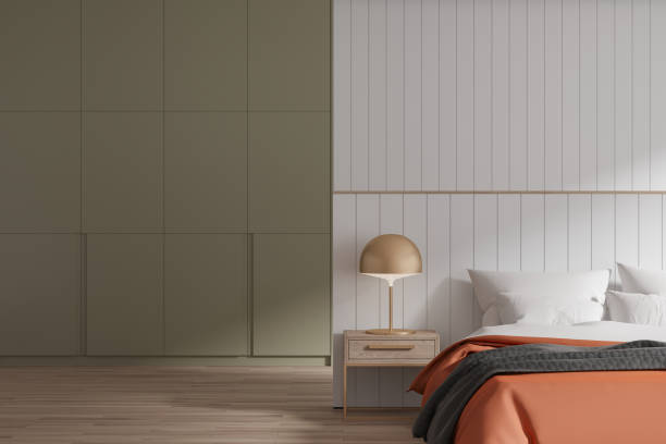 istock Luxury hotel bedroom interior with bed, nightstand and green shelf 1698498986