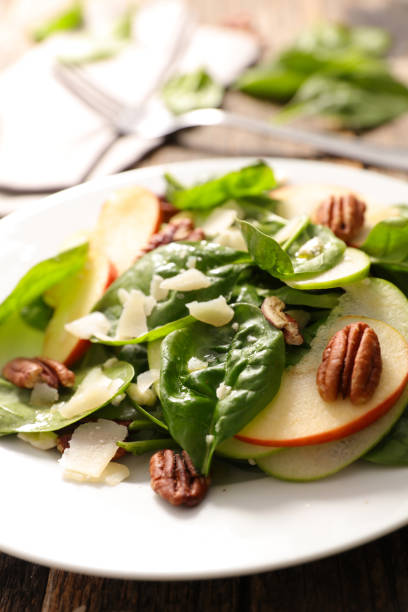istock Mixed salad with spinach, apple, pecan nut and parmesan 1698513027