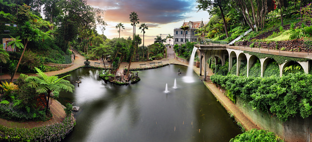 Funchal - Madeira, Monte Tropical Gardens with view of palace on lake at sunset, Portugal