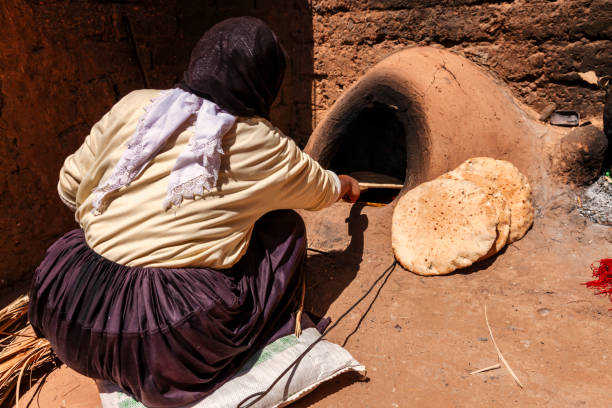 istock Moroccan woman making bread - khubz 1698538859