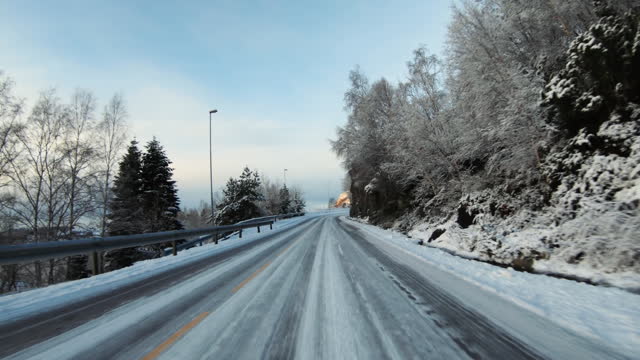POV car driving in snow: mountain pass in Norway