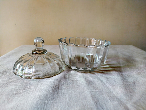 A glass sugar pot with glass cover for serving sugar in it