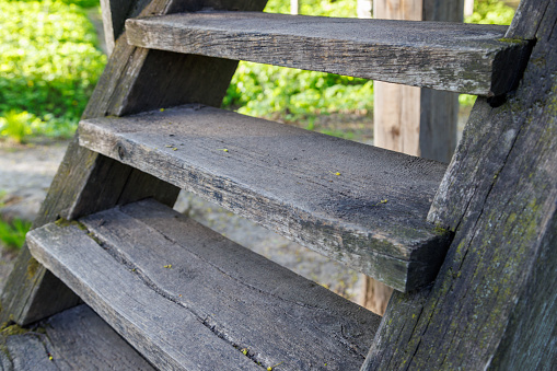 old dry wooden stairs at summer day, closeup with selective focus.