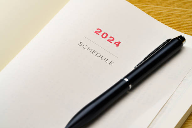 istock 2024 Notebook and pen on wooden table 1698602754