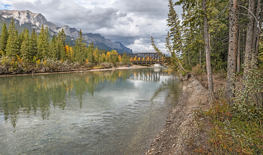Autumn view of the Bow River with Mount Rundle and the Engine Bridge in Canmore, Alberta, Canada