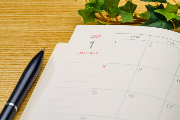 istock 2024 Notebook and pen on wooden table 1698605918