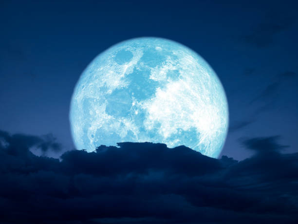 istock full harvest blue moon over dark heap cloud on night sky 1698612095