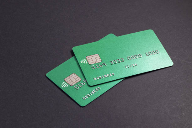 istock Two green credit cards on dark background. 1698613709