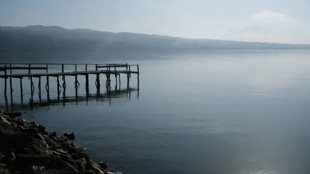 Photo of Small dock at the sea in the morning, viewed from side