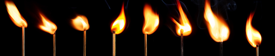 The stages of match burning on a black background. Safe match with red head. Different stages of matchstick burning. From Ignition to decay. Copy space, banner.