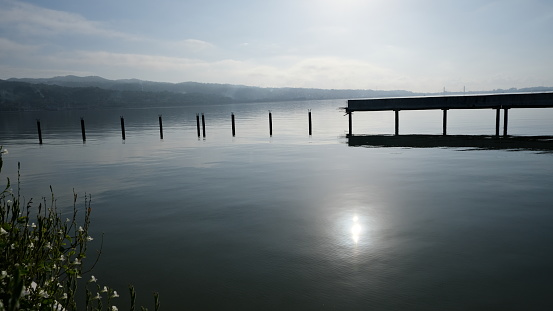 Broken bridge over the sea in silhouette,