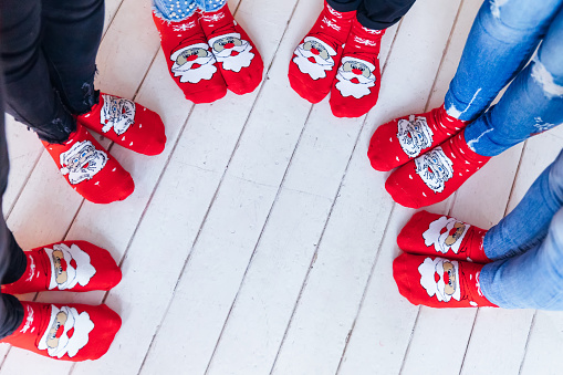 top view of female feet in red socks. girls lined up in a circle.