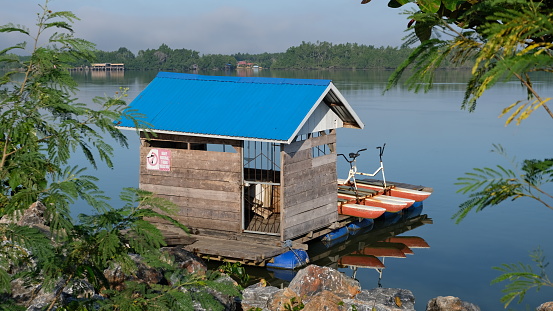 Small floating house in the river bank