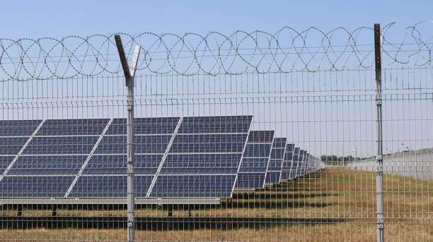 istock solar panels behind a fence in a field 1698637577
