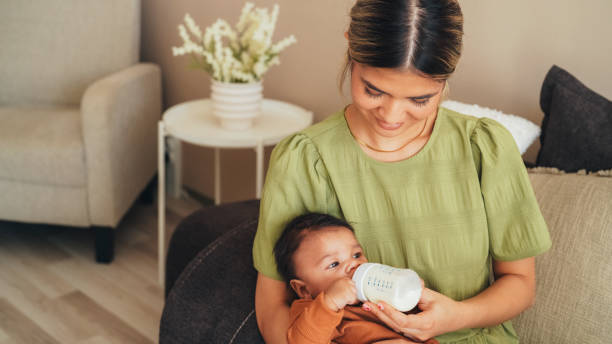 istock Mother bottle-feeding her newborn baby boy 1698643089