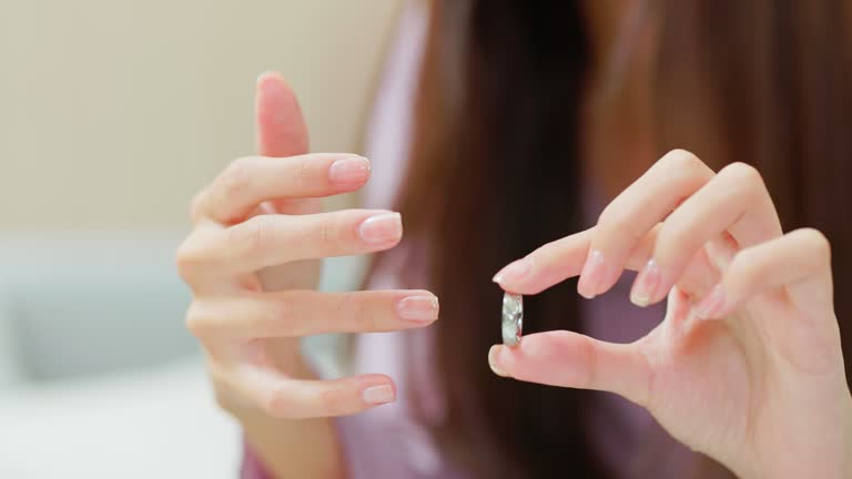 woman pulling ring off finger