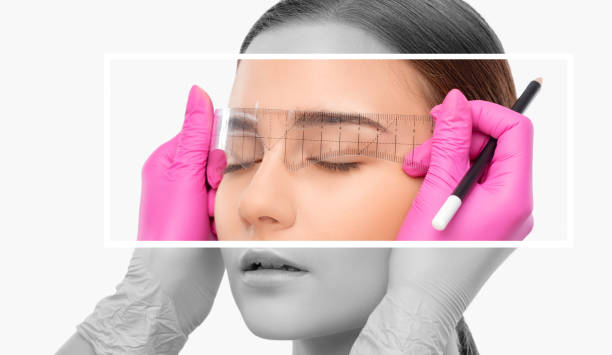 istock Make-up artist makes markings with white pencil for eyebrow and paints eyebrows. Professional makeup and facial care. 1698675765