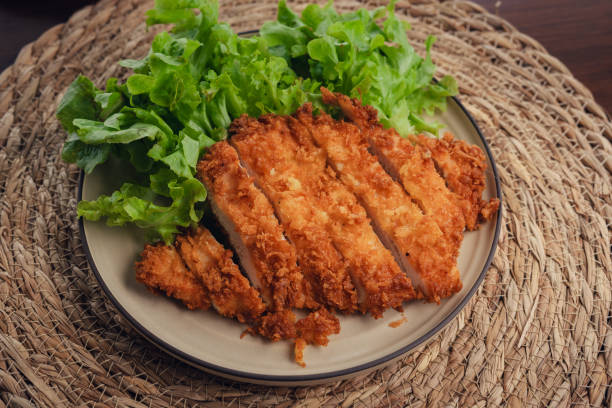 istock Deep fried chicken cutlet and salad vegetables 1698690959
