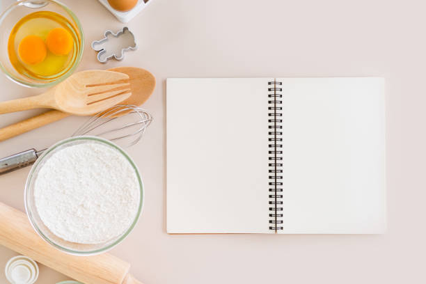 istock Blank notepad on a white background. Culinary cooking baking concept, place for a recipe. Top view. 1698692711