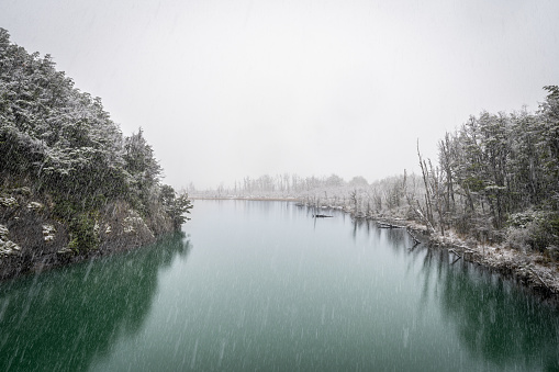 Ibanez river flowing through snowy forests in the chilean Patagonia