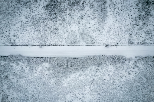 Aerial view of a road crossing snowy forests in Patagonia